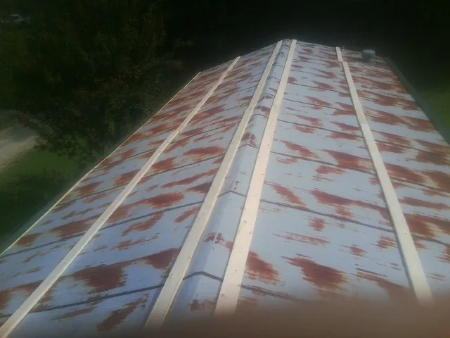 Rusted metal roof panels with new wood purlins before replacement — Storm Damage Roof Repair in Rossburg by Roofing Brothers